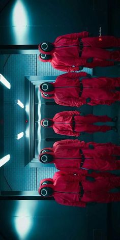 four people in red outfits standing together