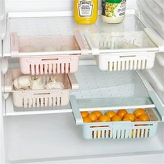 an open refrigerator filled with oranges and other food items, including juice in containers