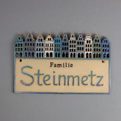 a family name plate with houses on it and the words stemmetz written in blue