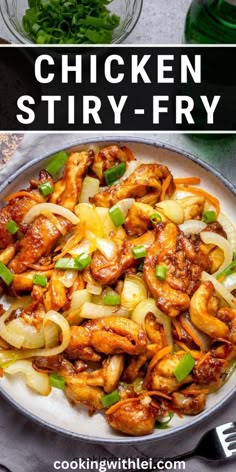 chicken stir fry in a pan with onions and green peppers on the side, next to a