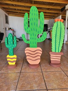 three large cactus shaped planters sitting on top of a tile floor next to each other