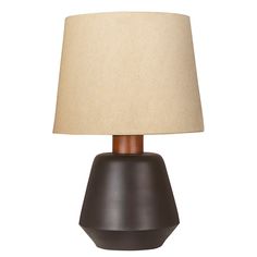 a table lamp with a brown base and a beige shade on the top of it