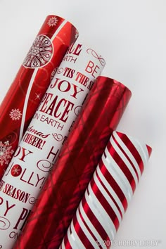 three red and white christmas wrappings on top of each other next to one another