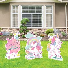 three little unicorns standing in front of a house with lawn decorations on the lawn