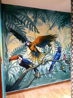 a painting of birds on a tree branch in front of a wall with palm leaves