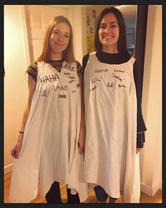 two young women standing next to each other in dresses with words written on the back