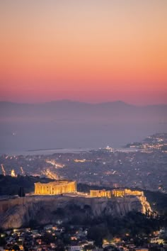 the acrobatic view of the parthenon at night from atop the hill