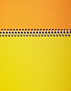 an orange and yellow background with a spiral notebook in the middle that has been turned upside down