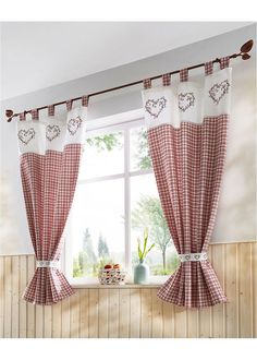 a living room filled with furniture and windows covered in red checkerboard curtains next to a window