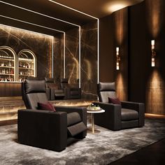 a living room filled with black furniture and a bar in the backround behind it