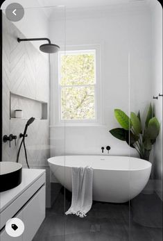 a white bath tub sitting next to a window