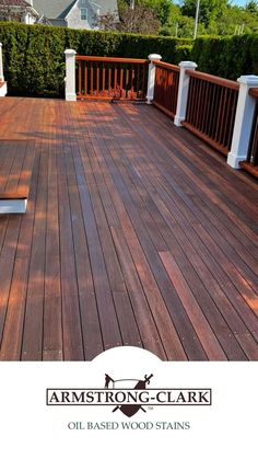 a wooden deck with white railings and wood slats on the bottom half of it