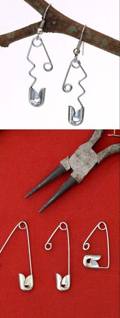 three pairs of scissors and some wire on a red table next to a pair of earrings