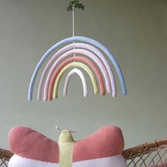 a rainbow shaped pillow hanging from a string