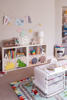 a child's room with toys and bookshelves on the wall, carpeted floor