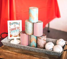 baseballs and other items in a metal container on a table