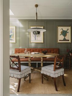 a dining room table with two chairs and a bench in front of the couches