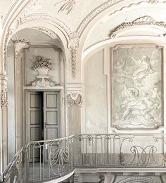 an old building with stairs and paintings on the walls