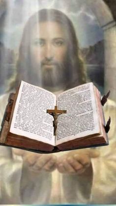 an open book with the image of jesus on it