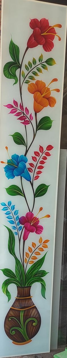 this is an image of a vase with flowers painted on the glass wall behind it