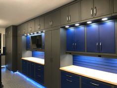 a kitchen with blue cabinets and lights on the side wall, along with an oven