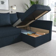 a blue couch with an open storage compartment