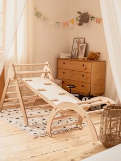 a child's bed with a wooden sleigh on the floor