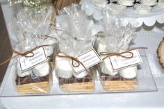 cookies and marshmallows wrapped in cellophane are displayed on a table