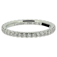 Here we have a classic diamond full eternity ring from the world renowned jewellery house of Cartier. The band has been crafted from 18ct white gold and plays host to 35 round brilliant cut diamonds; all of which have been individually claw set in a single line formation. As expected from Cartier the diamonds are perfectly matched in terms of colour, clarity and presence. Condition: Used (Excellent) - Professionally polished to appear brand new Weight: 1.5 grams Ring Size: I (47) Band Width: 2mm Total Diamond Weight: Approx. 0.40ct Diamond Details: Colour: F-G, Clarity: VVS-VS Marked: 'Cartier' '46' 'Au750' RRP: £5,200 Documents: Cartier Certificate of Authenticity Box: Cartier Ring Box Vintage Cartier Watch, Full Eternity Ring, Eternity Band Ring, Half Eternity Ring, Gold Band Ring, Modern Ring, Eternity Ring Diamond, Eternity Band Diamond, Diamond Eternity