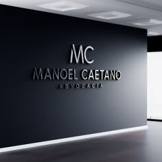 a black and white photo of a mandel catanoo logo on the wall