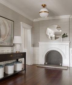 a living room filled with furniture and a fire place next to a painting on the wall