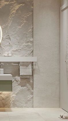 a bathroom with a sink, mirror and towel rack on the wall next to it