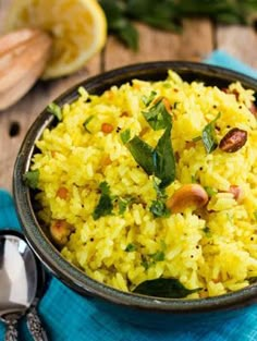 a bowl filled with yellow rice and nuts