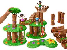 a play set with trees and people in the tree house, including two children's toys