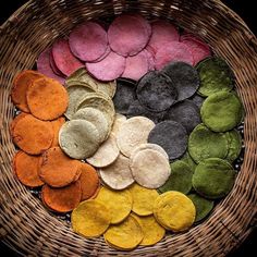 a basket filled with lots of different colored cookies