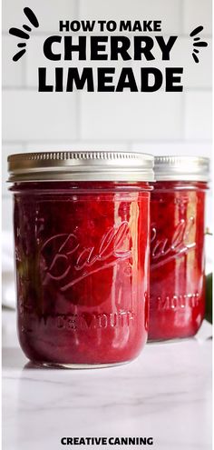 two mason jars filled with cherry limeade sitting on top of a white countertop