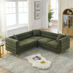 a green sectional couch sitting on top of a rug