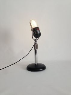 an old fashioned microphone is plugged into a cord