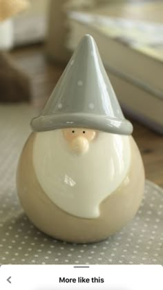 a ceramic gnome figurine sitting on top of a table