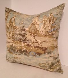 a decorative pillow with an image of people and animals in the background on a white surface