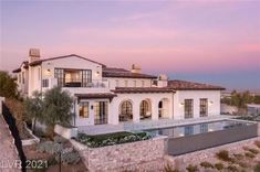 a large house with a pool in front of it