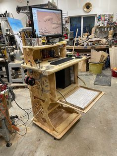 a workbench in a workshop with many tools and materials on it, including a computer screen