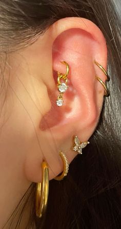 a close up of a person with ear piercings on their ears and behind the ear