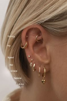 a woman's ear is shown with different types of piercings on her ears