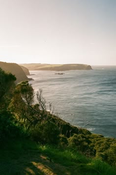 a bench on the edge of a cliff overlooking the ocean