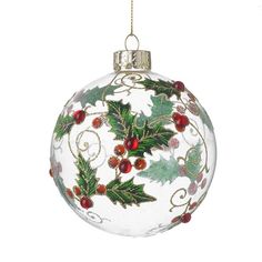 a glass ornament with holly and berries on it