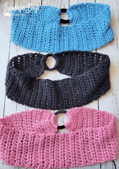 three crocheted headbands with holes in them on a white wooden surface