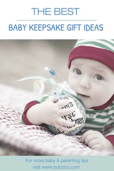 a baby is holding a christmas ornament with the words, the best baby keepsake gift ideas