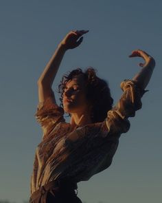 a woman with her arms in the air