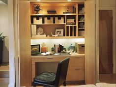 a chair sitting in front of a desk under a book shelf filled with lots of books